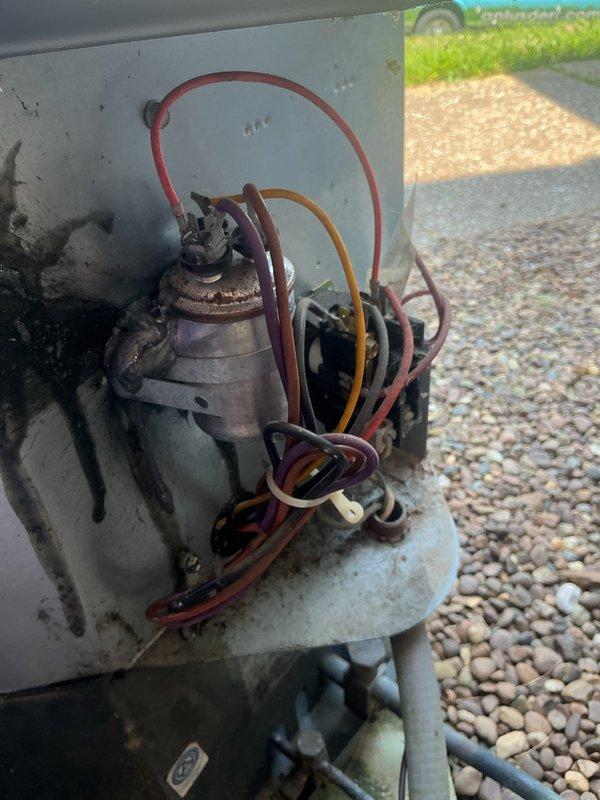 # HVAC Service Completed

Responded to no cooling complaint with indoor temperature reported at 84 degrees and no airflow from system. Upon arrival, tenant was unavailable for contact. Accessed property using provided maintenance information and located outdoor condensing unit and indoor air handler.

Performed visual inspection of outdoor HVAC unit, observing compressor assembly with multiple refrigerant lines connected. Equipment showed normal weathering consistent with age but no obvious external damage. Checked electrical connections and refrigerant line routing at outdoor unit. Photographed compressor configuration and refrigerant line connections showing red, orange, and purple service hoses attached to unit mounted on concrete pad.

Inspected indoor air handler located in utility closet accessed through louvered door. Verified air handler installation and checked for obvious mechanical or electrical issues. Photographed air handler location and accessibility for service records.