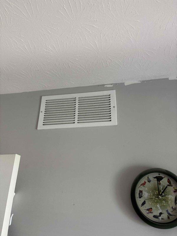 Responded to concern regarding inadequate cooling in front bedroom of residence with 2-year-old HVAC system. Performed visual inspection of supply register and ductwork serving affected area. Inspected ductwork routing through underfloor cavity, examining main trunk line and branch connections for potential airflow restrictions, disconnections, or damper issues. Verified supply vent condition and assessed air distribution pattern in bedroom. Documented existing ductwork configuration and structural layout for reference.