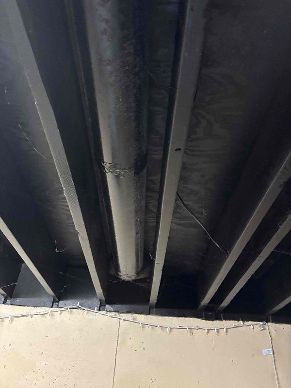 Responded to concern regarding inadequate cooling in front bedroom of residence with 2-year-old HVAC system. Performed visual inspection of supply register and ductwork serving affected area. Inspected ductwork routing through underfloor cavity, examining main trunk line and branch connections for potential airflow restrictions, disconnections, or damper issues. Verified supply vent condition and assessed air distribution pattern in bedroom. Documented existing ductwork configuration and structural layout for reference.