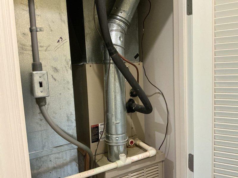 Completed comprehensive replacement estimate for residential property with three HVAC systems, focusing on one non-operational 21-year-old unit requiring full system replacement. Evaluated existing Lennox equipment installation in utility closet, including air handler with cylindrical plenum, flexible ductwork connections, electrical service, and PVC condensate drainage system. Documented current system configuration and provided replacement options per homeowner request for equipment upgrade only.