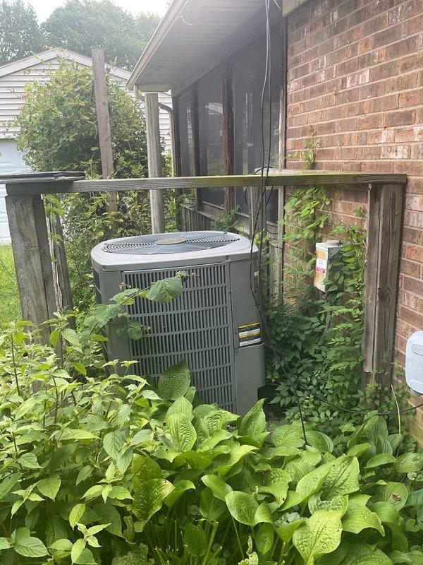 Conducted comprehensive HVAC system replacement estimate for non-functioning residential air conditioning system. Evaluated existing outdoor condenser unit positioned against brick exterior, assessed electrical panel capacity including dedicated circuit breaker configuration for HVAC equipment, and documented current system installation including concrete pad placement and clearance conditions with surrounding vegetation. Provided homeowner with complete replacement options and specifications for new system installation.