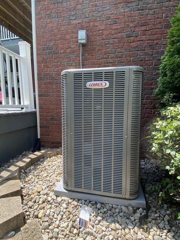 Completed full HVAC system installation including new Lennox furnace and air conditioning condenser unit. Installed furnace in basement utility area with proper metal ductwork connections, PVC condensate drain lines, and venting. Mounted outdoor Lennox AC condenser on concrete pad against exterior brick wall with proper electrical disconnect and conduit installation. Positioned unit in landscaped area with decorative rock surround for optimal airflow and drainage. Connected all electrical controls, refrigerant lines, and communication wiring between indoor and outdoor components. Verified all manufacturer specifications, tested system operation, and confirmed proper heating and cooling functionality throughout the residence.
