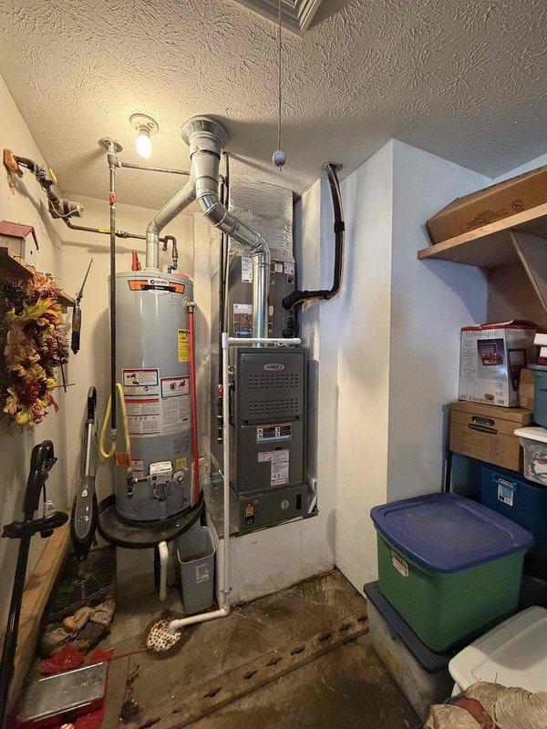 Completed full HVAC system installation including a 2.5-ton, 14.7 SEER air conditioning condenser unit positioned on gravel pad with proper refrigerant line routing and electrical disconnect, paired with an 80% efficiency gas furnace with integrated ductwork connections in utility room. System was upsold during service call, installed to manufacturer specifications, and tested for proper operation with all components functioning as designed.