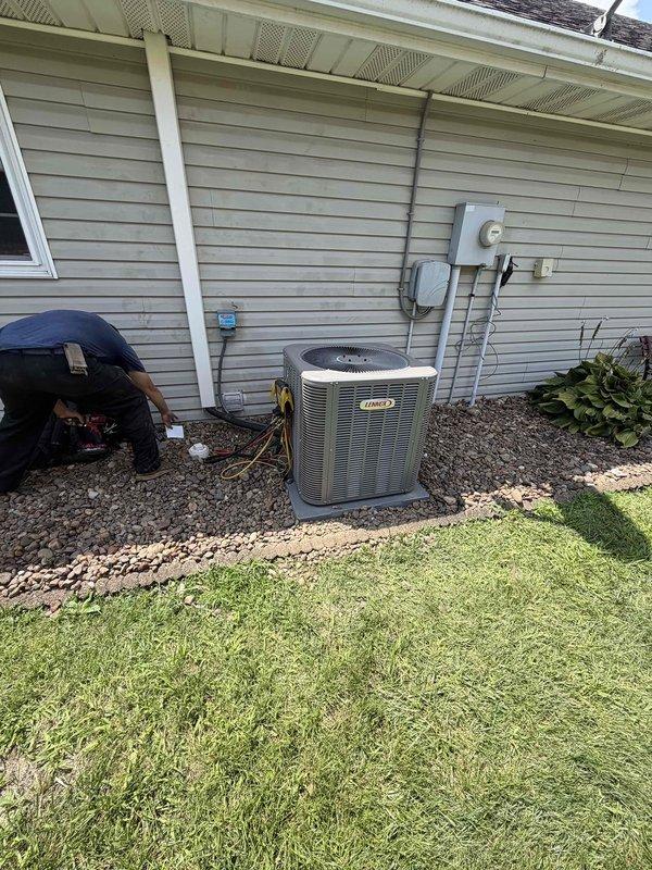 Completed full HVAC system installation including a 2.5-ton, 14.7 SEER air conditioning condenser unit positioned on gravel pad with proper refrigerant line routing and electrical disconnect, paired with an 80% efficiency gas furnace with integrated ductwork connections in utility room. System was upsold during service call, installed to manufacturer specifications, and tested for proper operation with all components functioning as designed.