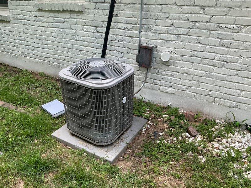 Conducted comprehensive on-site evaluation for complete HVAC system replacement estimate including outdoor condensing unit, indoor furnace, and water heater. Inspected existing air conditioning unit positioned on concrete pad against exterior brick wall, assessed electrical disconnect and refrigerant line routing. Evaluated indoor air distribution system including return air grille and ductwork accessibility. Documented current equipment conditions through photographic records to support multiple estimate scenarios: full HVAC and water heater replacement, furnace-only replacement, and water heater-only replacement. Provided customer with detailed options for equipment upgrade paths based on system assessment.