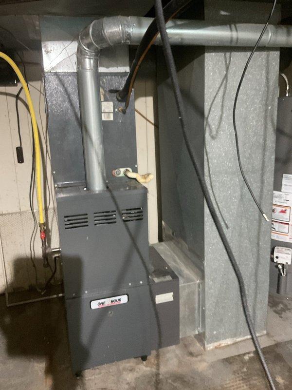 Completed comprehensive replacement estimate for residential HVAC system that has been non-operational for approximately one year. Assessed existing furnace and ductwork configuration in basement mechanical room, documenting current equipment condition including dark gray furnace unit with metal supply ductwork, electrical connections, and surrounding insulated enclosure. Evaluated replacement options and financing solutions for complete system installation to restore climate control functionality, as property currently relies on temporary window unit cooling.