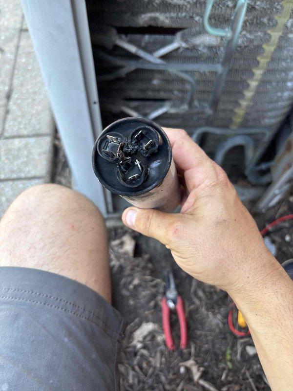 Responded to no cooling complaint on 7-year-old residential HVAC system with breaker tripping issue and no airflow. Upon arrival, found thermostat reading 78°F with indoor temperature at 92°F. System would run approximately 30 seconds after resetting breaker before shutting down again. Performed diagnostic evaluation and identified failed dual run capacitor as root cause of system shutdown. Capacitor showed visible signs of failure and tested outside acceptable microfarad range. Removed defective capacitor from outdoor condensing unit and installed new dual run capacitor with proper specifications. Verified all electrical connections were secure and tested system operation. Unit now running properly with normal amperage draw on compressor and condenser fan motor. System cooling effectively with adequate airflow restored throughout home.
