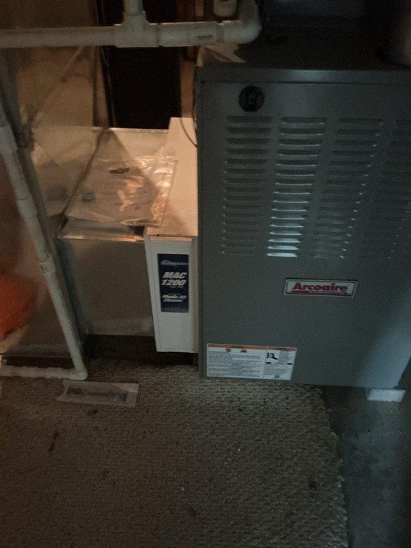 Completed comprehensive load calculation for HVAC system replacement, determining cooling load of 52,949 BTUh and heating load of 83,196 BTUh. Analysis revealed required cooling capacity of 4.9 tons at 0.75 SHR with 1714 CFM airflow needed. Evaluated existing Arcoaire furnace installation in basement mechanical room and documented current equipment configuration to provide accurate replacement estimate for system upgrade.