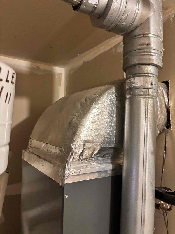 Responded to no cooling complaint on 7-year-old residential HVAC system. Upon arrival, confirmed adequate airflow from supply vents with no ice buildup present at indoor unit. System was actively running but delivering warm air to conditioned space. Performed visual inspection of air handler and associated refrigerant lines in utility closet. Investigated reported fluid leak concern around equipment area. Examined copper refrigerant lines, insulated suction line, and air handler cabinet for signs of refrigerant oil migration or other fluid discharge. Documented system installation configuration including ductwork connections and electrical components for diagnostic reference.
