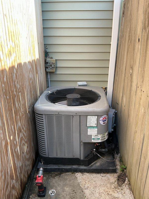 Responded to no-cool complaint on residential split system air conditioning unit with dual-fan condensing unit installed in narrow side yard location. Upon arrival, indoor temperature measured 79°F with outdoor ambient at 100°F, indicating insufficient cooling capacity. Performed complete system evaluation including visual inspection of outdoor condensing unit, verification of thermostat operation showing 72°F setpoint, and assessment of airflow from both condenser fans. Condensing unit appeared operational with both fans running, but system unable to maintain desired temperature during extreme heat conditions. Documented equipment configuration and current operating conditions with photographic evidence. Advised customer on potential causes for inadequate cooling performance during peak load conditions, including possible refrigerant charge issues, airflow restrictions, or undersized equipment for cooling load demands. Recommended follow-up diagnostic testing to determine root cause o