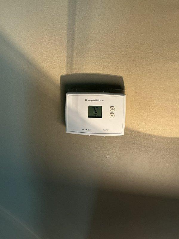 Responded to no-cool complaint on residential split system air conditioning unit with dual-fan condensing unit installed in narrow side yard location. Upon arrival, indoor temperature measured 79°F with outdoor ambient at 100°F, indicating insufficient cooling capacity. Performed complete system evaluation including visual inspection of outdoor condensing unit, verification of thermostat operation showing 72°F setpoint, and assessment of airflow from both condenser fans. Condensing unit appeared operational with both fans running, but system unable to maintain desired temperature during extreme heat conditions. Documented equipment configuration and current operating conditions with photographic evidence. Advised customer on potential causes for inadequate cooling performance during peak load conditions, including possible refrigerant charge issues, airflow restrictions, or undersized equipment for cooling load demands. Recommended follow-up diagnostic testing to determine root cause o
