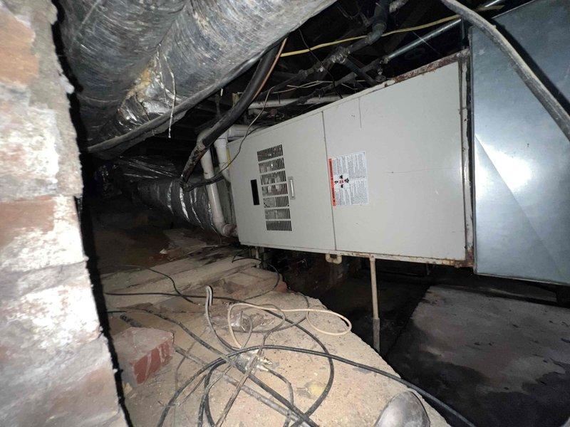 Conducted comprehensive assessment of 18-year-old cooling system located in basement crawl space of large residential property exceeding 2,200 square feet. Evaluated existing air handling unit, ductwork infrastructure, and overall system condition to provide complete replacement estimate. Documented equipment specifications, existing installation configuration, flexible duct conditions, and accessibility constraints within confined crawl space environment for full system replacement proposal.