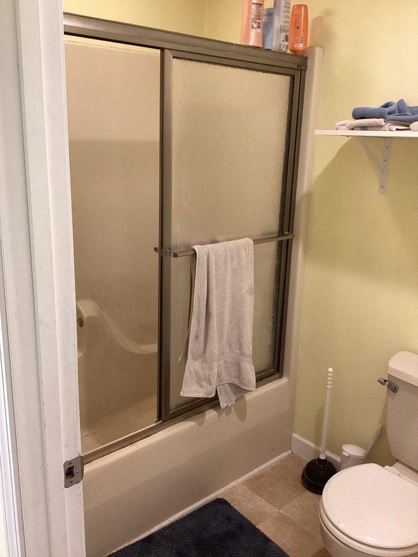 Provided estimate for conversion of existing tub/shower combination to stand-alone shower unit at residential property. Assessed current bronze-framed glass enclosure and white bathtub with failing fixtures experiencing continuous dripping issues. Presented cost-effective options for shower-only installation in same location, including fixture replacement recommendations and enclosure modifications to address deteriorating components while minimizing structural changes.