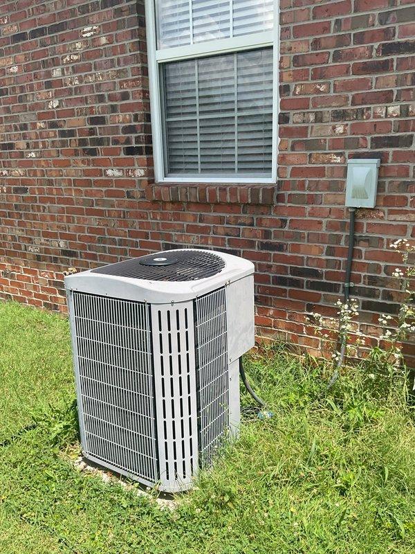 Conducted comprehensive replacement estimate for existing HVAC system at residential property. Evaluated current Carrier furnace unit located in garage alongside water heater, assessing ductwork connections, ventilation routing, and existing infrastructure. Inspected outdoor condenser unit positioned on concrete pad against brick exterior wall, noting electrical disconnect configuration and overall system condition. Documented equipment specifications, spatial constraints for new installation, and provided homeowner with replacement options for complete heating and cooling system upgrade.