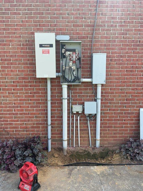 Completed follow-up site visit for electrical transfer switch installation. Verified proper installation of Generac automatic transfer switch with associated electrical panels, conduit runs, and circuit protection devices. Interior panels mounted and secured with appropriate clearances, exterior transfer switch equipment properly weatherproofed and configured on brick exterior with PVC conduit system routed from grade level. All connections inspected, system tested and confirmed operational.