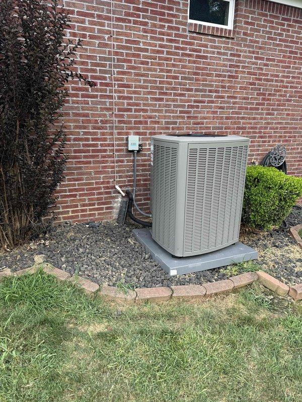 Completed installation of a 4-ton, 18 SEER air conditioning system with zoning capabilities. The outdoor condensing unit was positioned on a concrete pad against the exterior brick wall with proper clearance and landscaping considerations, while the indoor air handler was installed in the attic space with multiple zone ducts properly insulated and secured. All refrigerant lines, condensate drainage, electrical disconnect, and ductwork connections were completed to manufacturer specifications, and the system was tested and left operational.