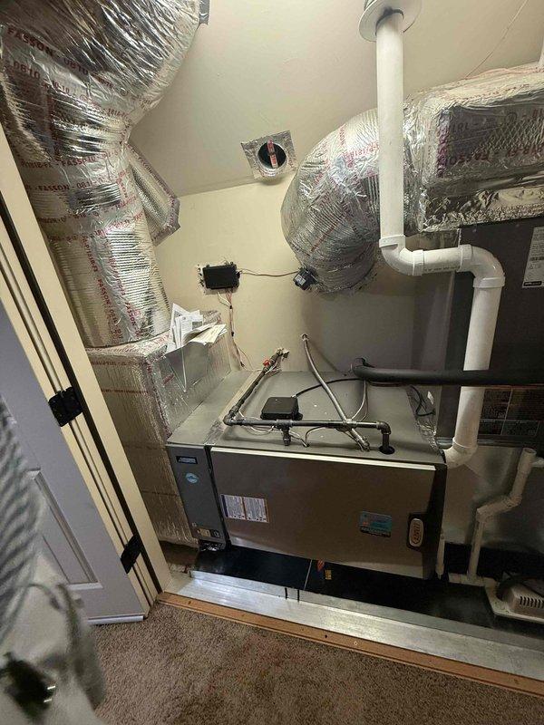 Completed installation of a 4-ton, 18 SEER air conditioning system with zoning capabilities. The outdoor condensing unit was positioned on a concrete pad against the exterior brick wall with proper clearance and landscaping considerations, while the indoor air handler was installed in the attic space with multiple zone ducts properly insulated and secured. All refrigerant lines, condensate drainage, electrical disconnect, and ductwork connections were completed to manufacturer specifications, and the system was tested and left operational.