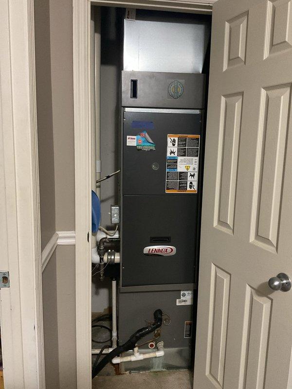 Conducted comprehensive assessment of seventeen-year-old Lennox residential air conditioning system for replacement estimate. Evaluated outdoor condenser unit positioned on concrete pad and indoor vertical air handler installed in utility closet, documenting equipment specifications, installation configuration, electrical connections, and condensate drainage system to provide accurate replacement system recommendations.