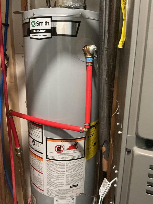 Completed full installation of an A.O. Smith ProLine commercial-grade water heater in utility room. Connected all supply and discharge lines using copper piping and PEX tubing with proper fittings, installed braided stainless steel flexible connectors, and ensured all safety valves and controls were properly mounted and operational per manufacturer specifications.