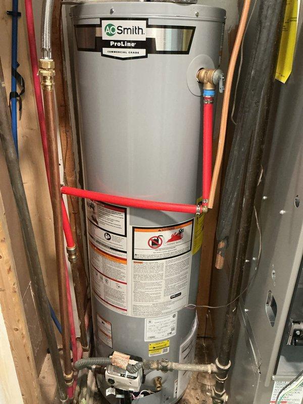 Completed full installation of an A.O. Smith ProLine commercial-grade water heater in utility room. Connected all supply and discharge lines using copper piping and PEX tubing with proper fittings, installed braided stainless steel flexible connectors, and ensured all safety valves and controls were properly mounted and operational per manufacturer specifications.