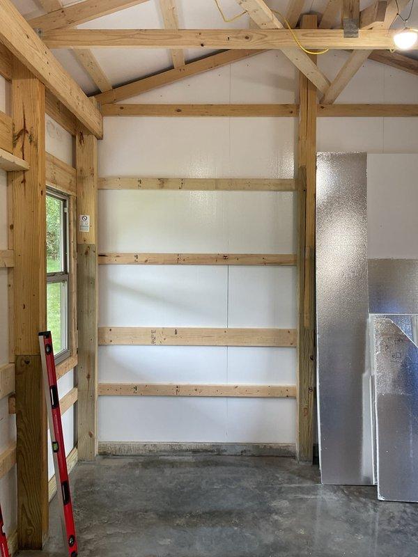 Completed HVAC estimate for new construction pole barn installation. Assessed open interior space with cathedral ceiling and exposed wooden beam construction to determine appropriate system sizing and equipment placement. Evaluated structural layout including concrete flooring, wall framing, and existing ductwork positioning for optimal heating and cooling solution design.