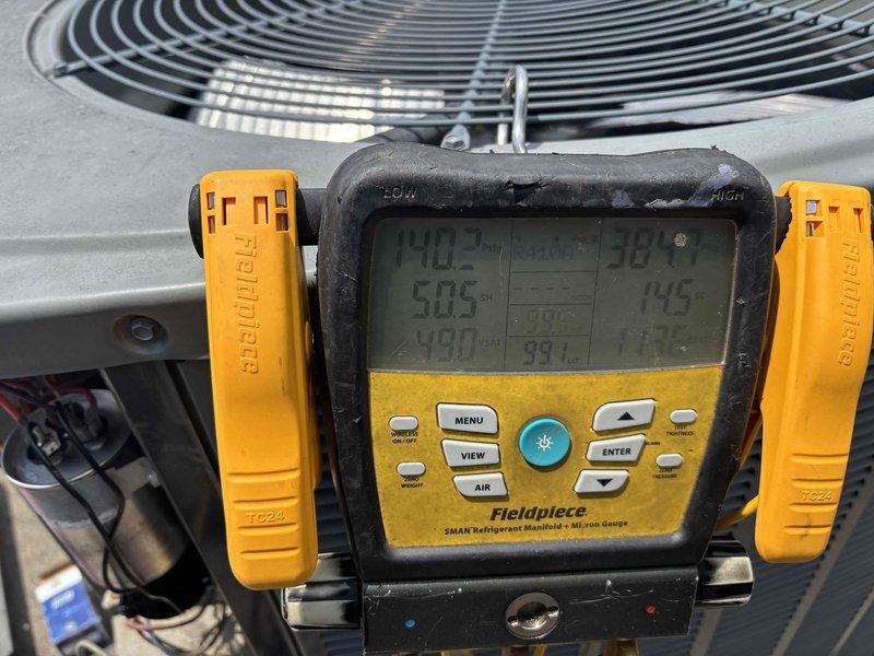 Responded to no cooling complaint on 7-year-old residential HVAC system with indoor temperature at 79°F and thermostat set to 70°F. Upon arrival, confirmed system was not operational with no airflow from vents and no tripped breakers. Performed diagnostic testing using refrigerant manifold and micron gauge at outdoor condenser unit, measuring system pressures and temperatures to identify failure point. Inspection revealed failed dual-run capacitor in condenser unit showing significant oxidation, corrosion, and deterioration. Replaced defective Genteq capacitor with proper rated replacement. Verified all electrical connections, tested system operation, and confirmed proper cooling function restored with adequate airflow and temperature differential.