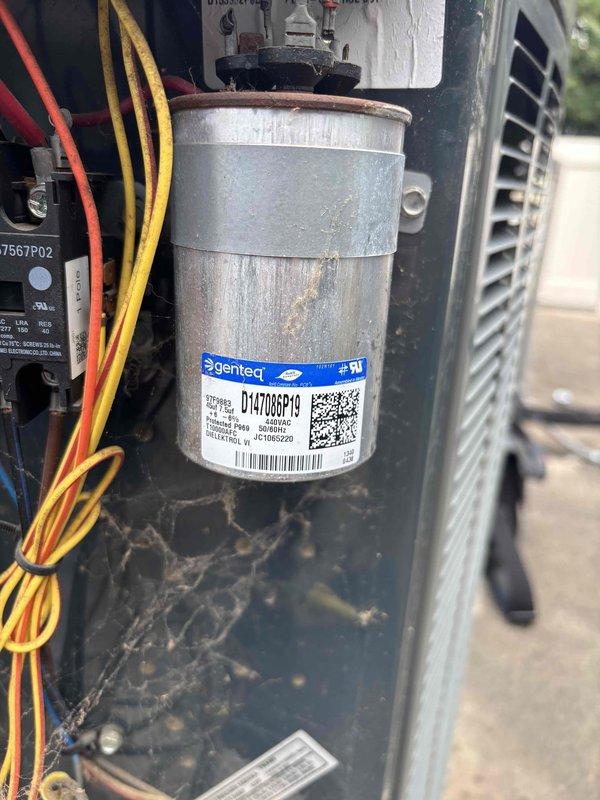 Responded to no cooling complaint on 7-year-old residential HVAC system with indoor temperature at 79°F and thermostat set to 70°F. Upon arrival, confirmed system was not operational with no airflow from vents and no tripped breakers. Performed diagnostic testing using refrigerant manifold and micron gauge at outdoor condenser unit, measuring system pressures and temperatures to identify failure point. Inspection revealed failed dual-run capacitor in condenser unit showing significant oxidation, corrosion, and deterioration. Replaced defective Genteq capacitor with proper rated replacement. Verified all electrical connections, tested system operation, and confirmed proper cooling function restored with adequate airflow and temperature differential.