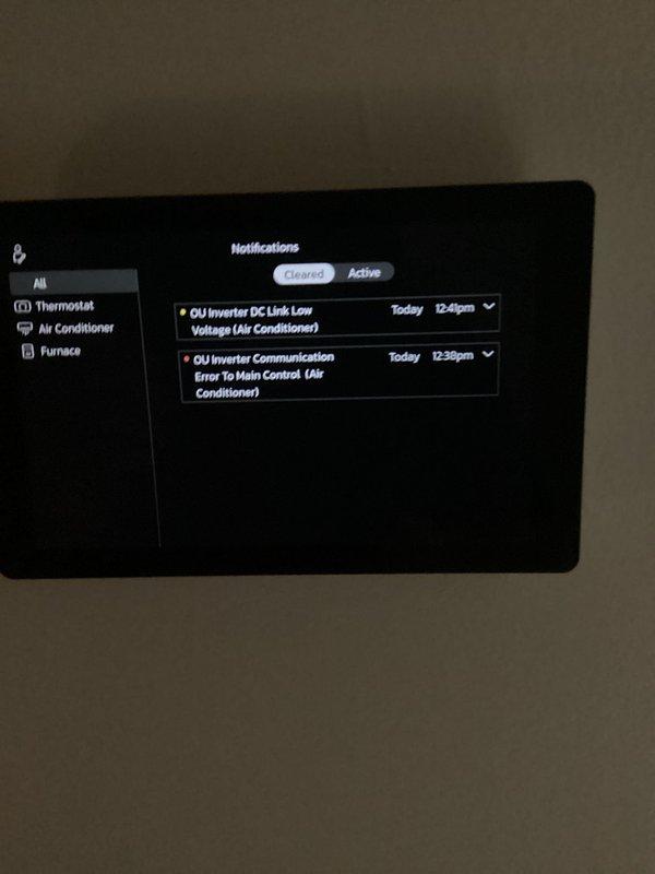 Responded to callback for 3-month-old AC system with non-operational outdoor unit and thermostat communication failure. Upon arrival, reviewed thermostat notifications showing two cleared fault codes: OU Inverter DC Link Low Voltage and OU Inverter Communication Error to Main Control. Inspected electrical panel and verified proper wiring connections to system components. Photographed thermostat error log and electrical panel configuration for documentation. System diagnostics confirmed inverter communication issues were resolved, outdoor unit restored to normal operation, and thermostat communication re-established with all HVAC equipment.