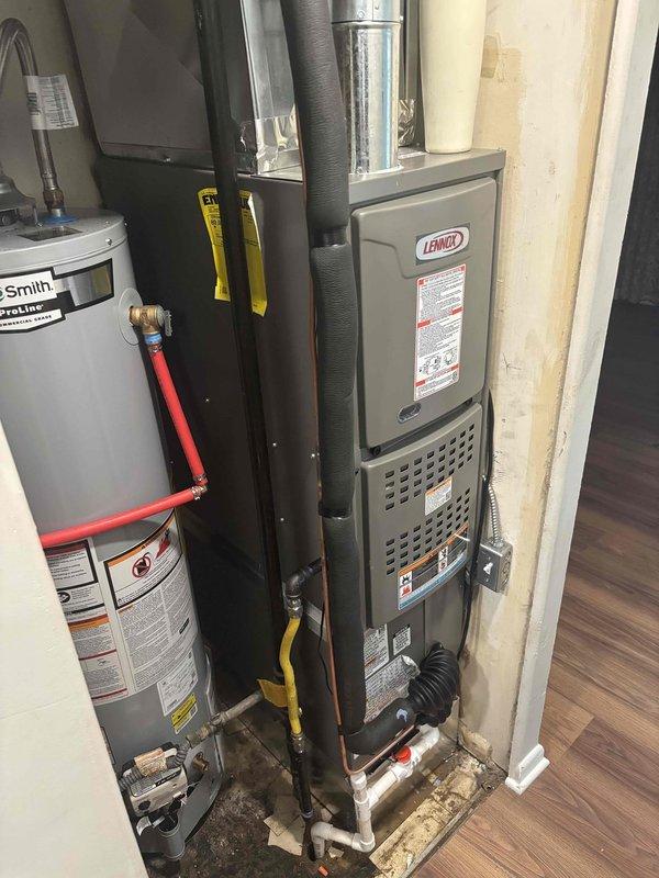 Completed full HVAC system installation including Lennox furnace with integrated controls and A.O. Smith ProLine 30-gallon water heater. All equipment properly installed, connected, and tested with control boards wired and operational, flexible ductwork secured, and gas/water lines connected per manufacturer specifications.