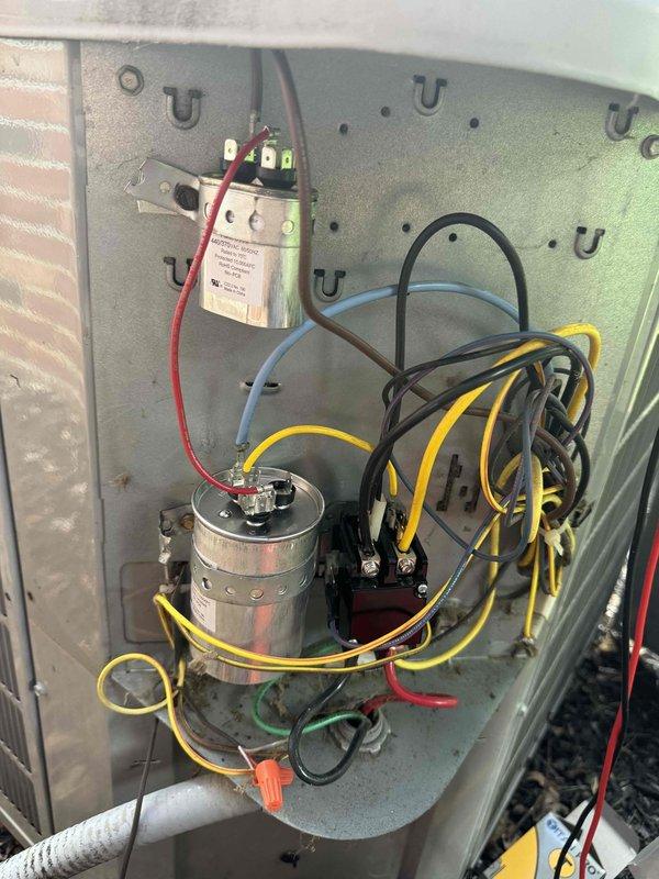 Responded to no cooling complaint with thermostat reading in the 80s and fan running but no cool air production. Upon inspection of the outdoor unit's electrical compartment, diagnosed failed dual run capacitor preventing compressor operation. Verified capacitor failure using digital multimeter with reading of 83.6 microfarads, which was significantly below manufacturer specifications. Replaced defective capacitor with OEM equivalent, reconnected all electrical connections, and restored power to system. Tested unit operation and confirmed compressor engagement, proper amperage draw, and adequate cooling airflow at registers. System returned to normal operation with satisfactory temperature differential.