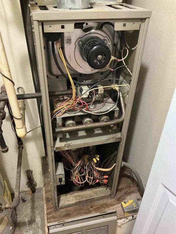 Responded to follow-up service call for water leak reported after 5-6 hours of system operation. Upon arrival, inspected HVAC furnace unit and surrounding components including ductwork, condensate drainage system, and associated piping. Conducted thorough visual examination of the unit's internal components, blower assembly, control board, and all visible connections. Photographed the installation to document the current condition of the system, including the furnace cabinet with access panel removed, copper and PVC piping, and ductwork connections with foam insulation. Identified potential leak sources in the condensate drainage system and inspected all pipe connections, joints, and drain lines for proper installation and secure fittings. Verified the integrity of the condensate pump operation and drainage pathway to ensure proper water evacuation from the system during cooling operation.