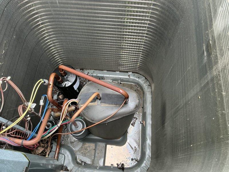 Performed follow-up leak search on HVAC system as previously identified. Conducted thorough inspection of evaporator coil assembly, refrigerant lines, and condensate pan area. Documented copper refrigerant piping connections and evaporator coil housing with photographic evidence showing potential leak locations at line set connections and coil interface points for repair authorization.