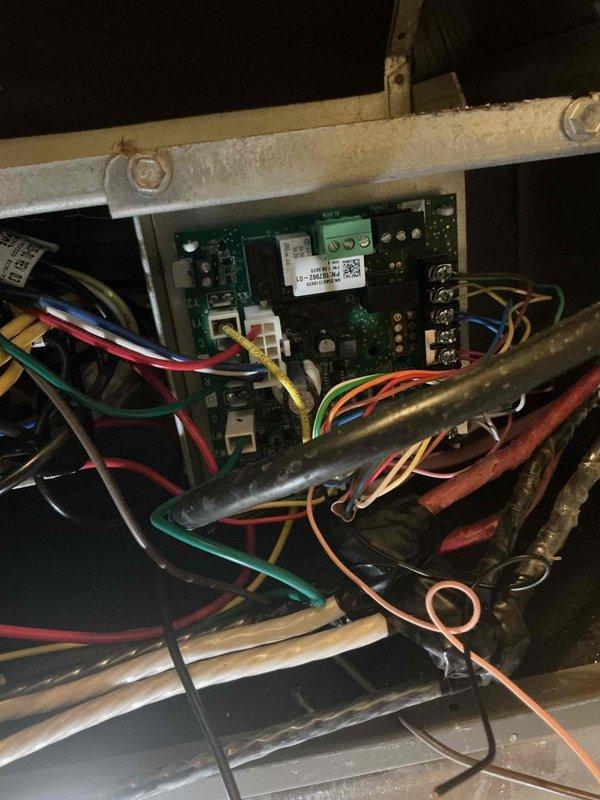 Responded to follow-up service call for HVAC system reported as not maintaining desired temperature during extreme heat conditions. Performed comprehensive inspection of unit's electrical control panel and wiring systems in attic installation. Verified all wire connections at terminal blocks, inspected control board components including capacitors and relays for proper operation, and documented system configuration with photos of control panel and wiring harness. All electrical connections found secure with no signs of loose terminals or damaged conductors. System scheduled for additional evaluation during next available service window to monitor performance under continued high ambient temperature conditions.