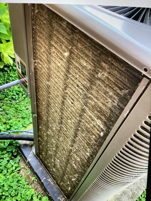 Completed AC tune-up maintenance visit with focus on outdoor condensing unit cleaning. Performed initial brushing of heavily soiled condenser coils which showed significant accumulation of dirt, dust, and debris between fins. Unit requires follow-up visit for thorough coil washing and pressure verification once plumbing repairs are completed to address existing system issues.