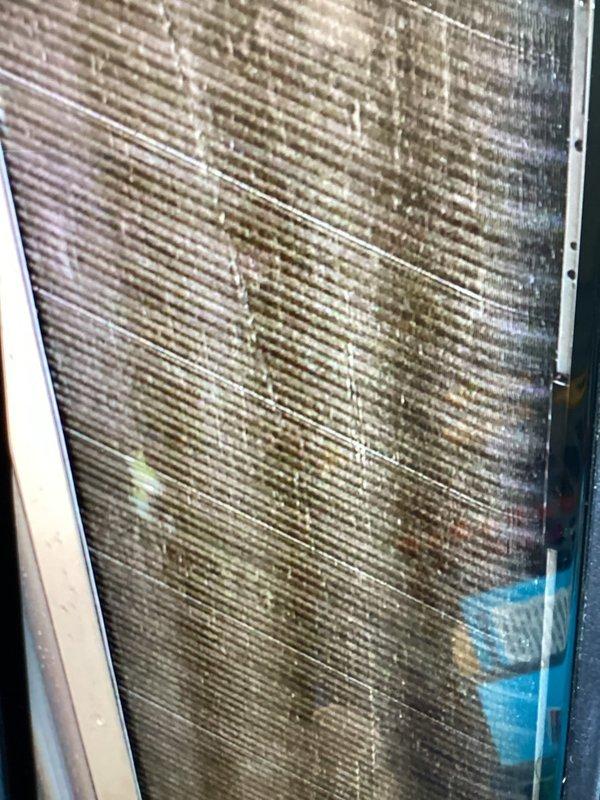 Completed AC tune-up maintenance visit with focus on outdoor condensing unit cleaning. Performed initial brushing of heavily soiled condenser coils which showed significant accumulation of dirt, dust, and debris between fins. Unit requires follow-up visit for thorough coil washing and pressure verification once plumbing repairs are completed to address existing system issues.