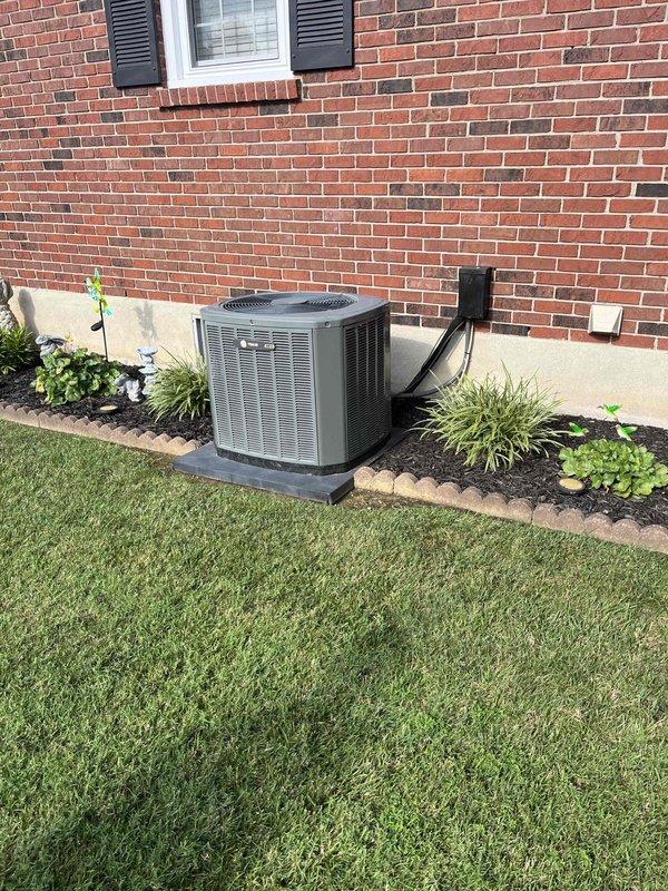 Conducted on-site evaluation for air conditioning condenser replacement at residential property. Assessed existing outdoor condenser unit positioned on concrete pad along exterior brick wall foundation, with electrical disconnect and conduit present. Inspected interior HVAC components including vertical and horizontal ductwork with reflective insulation in basement mechanical room. Documented current system configuration through photographs of outdoor condenser unit and indoor air distribution system. Provided estimate for new condenser installation to homeowner who was uncertain of existing unit's age and service history.