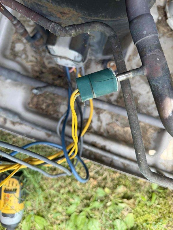 Responded to no cooling complaint for furnace unit #5 serving conference room area. Located and inspected outdoor condensing unit positioned against brick exterior wall. Performed diagnostic evaluation of system components including visual inspection of capacitor, refrigerant lines, and electrical connections. Unit showed signs of age with weathering and surface corrosion on cabinet and refrigerant piping. Assessed capacitor condition, wiring integrity, and overall system operation to determine cause of cooling failure and restore proper function to affected zone.