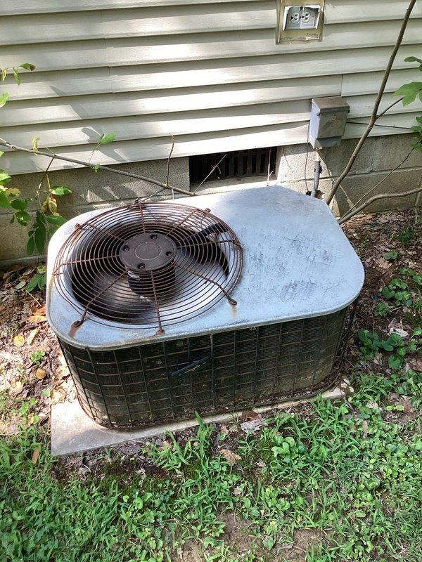 Responded to new customer inquiry for HVAC system replacement estimate. Evaluated aging outdoor condenser unit showing significant weathering, discoloration, and deteriorated top surface with visible patina, along with indoor furnace system located in utility closet. Documented existing equipment conditions through comprehensive photography, capturing outdoor unit positioned on concrete pad with worn components and indoor vertical furnace installation with associated ductwork and cylindrical heating components. Provided Green - A+ tier replacement estimate for complete HVAC system upgrade to address equipment age and performance concerns.