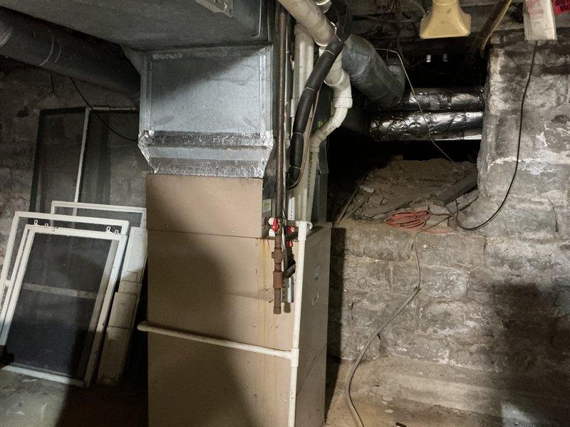 Conducted comprehensive HVAC replacement estimate for dual-system residential property. Evaluated aging outdoor condenser unit with significant wear and dirt accumulation, along with basement furnace installation requiring replacement. Documented existing equipment conditions, ductwork configurations, and installation parameters to provide homeowner with replacement options for both heating and cooling systems.