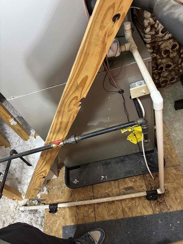 Responded to service call for air conditioning system that had shut down due to water accumulation in drain pan. Customer had cleared condensate drain line prior to arrival and unit was operational upon inspection. Performed thorough system evaluation including inspection of indoor air handler, drain pan, condensate drainage system, and outdoor Carrier condenser unit. Verified proper system operation, confirmed drain pan was empty and draining correctly, and assessed refrigerant lines for excessive condensation which may indicate insulation issues or airflow concerns. System tested and found to be functioning within normal parameters following customer's drain line maintenance.