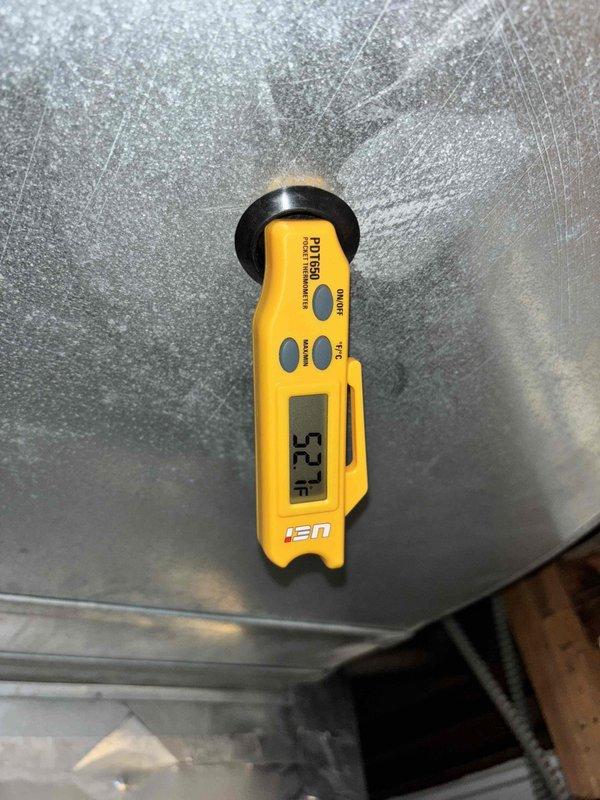 Responded to no-cool call on 2-year-old system with no airflow through vents and thermostat displaying "service urgent" error. Upon arrival, found indoor temperature rising from setpoint of 73°F to 76°F with complete loss of air circulation. Performed diagnostic evaluation of HVAC system including electrical components, air handler operation, and refrigerant circuit. Documented supply air temperature reading of 52.7°F and inspected mechanical room conditions, noting water damage on concrete floor near water heater that may require future attention but was unrelated to current HVAC issue. Identified system failure causing loss of cooling and airflow, completed necessary repairs to restore full system operation and verified proper function before departure.