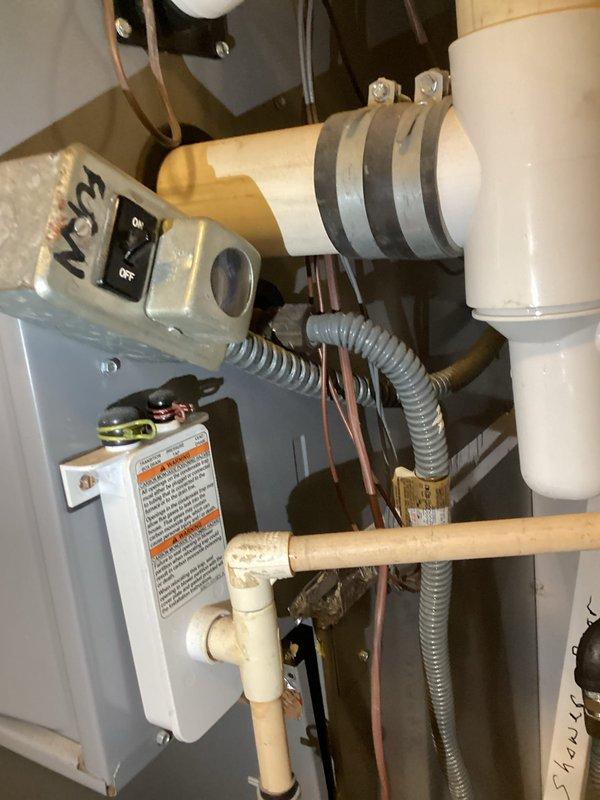 # HVAC Service Completed

Responded to service call for 15-year-old heat pump system with reported cooling failure and suspected refrigerant leak. Upon arrival, performed comprehensive system evaluation of mechanical equipment and refrigeration components.

Conducted visual inspection of indoor air handler unit, control panel, and associated mechanical equipment. Examined electrical disconnect box, copper refrigerant lines, and PVC condensate drainage system. Noted age-related wear on insulation materials covering refrigerant lines, with evidence of deterioration on foam insulation wrapping. 

Performed leak detection procedures on refrigerant circuit, checking all brazed joints, service ports, and connection points throughout the system. Inspected copper tubing runs for signs of corrosion, physical damage, or compromised integrity. Evaluated condition of linesets between indoor and outdoor units.

Checked electrical connections at control panel and verified proper operation of safety 