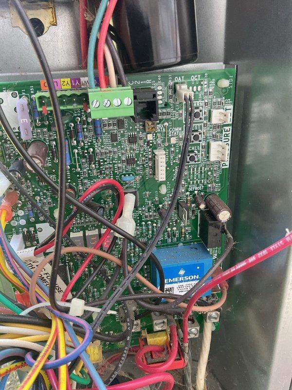 Responded to no-cooling complaint on 4-year-old residential HVAC system where outdoor unit was running continuously without cycling off. Upon arrival, performed diagnostic evaluation of condensing unit and control board operations. Connected manifold gauges to measure refrigerant pressures and inspected electrical components including circuit boards, capacitors, and contactor assembly. Identified issue with outdoor unit failing to respond to thermostat call properly, causing continuous operation regardless of indoor temperature demand. Inspected Emerson control board for proper relay function and verified all wire connections at terminal blocks. Checked capacitor values and contactor operation to rule out mechanical failure. System was cycling properly at time of inspection after being turned off overnight by homeowner. Advised on proper thermostat operation and system monitoring going forward.