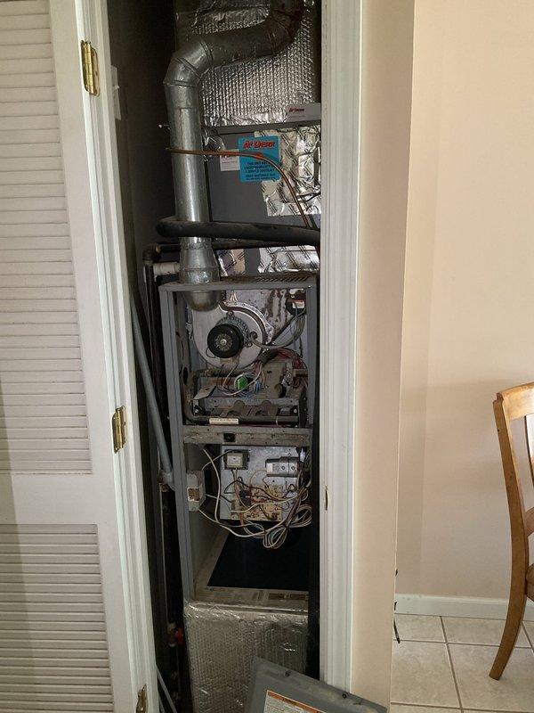 Responded to no cooling call on 22-year-old system with complete loss of power and non-responsive thermostat. Upon arrival, confirmed outdoor condenser unit and indoor air handler had no power. Customer reported possible wire damage near outdoor unit from weed trimming activity. Traced low-voltage wiring from thermostat through air handler to outdoor disconnect and located severed thermostat wire approximately 18 inches from condenser unit where landscape maintenance had occurred. Repaired damaged 18/5 thermostat control wire, restored all connections, and verified proper voltage at thermostat base and equipment terminals. Cycled system through complete operational test including compressor startup, blower motor function, and thermostat communication. All components responded correctly with normal amp draws. System restored to full cooling operation with proper airflow and refrigerant cycling. Advised property owner of repair completion and recommended care around low-voltage wiring du
