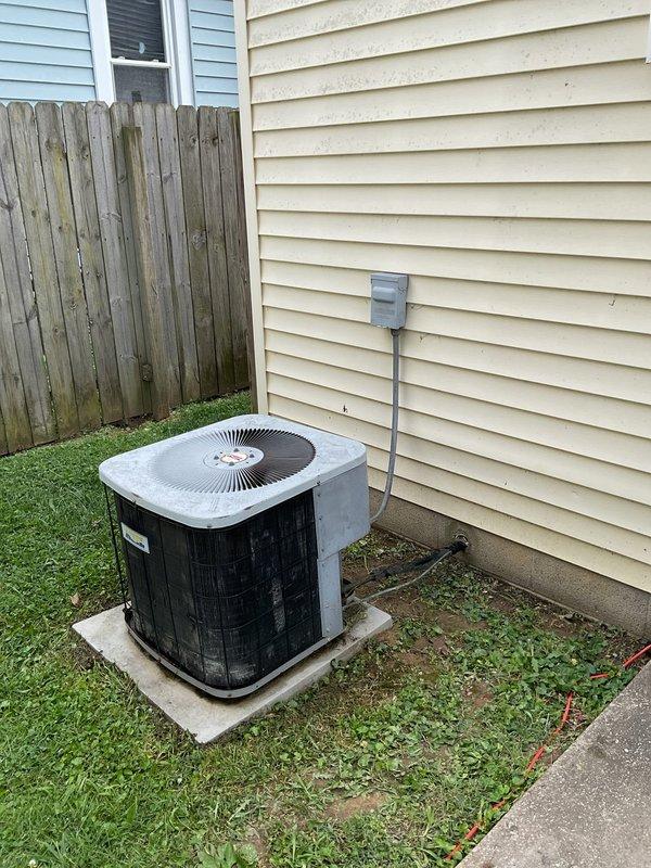 Responded to no cooling call on 22-year-old system with complete loss of power and non-responsive thermostat. Upon arrival, confirmed outdoor condenser unit and indoor air handler had no power. Customer reported possible wire damage near outdoor unit from weed trimming activity. Traced low-voltage wiring from thermostat through air handler to outdoor disconnect and located severed thermostat wire approximately 18 inches from condenser unit where landscape maintenance had occurred. Repaired damaged 18/5 thermostat control wire, restored all connections, and verified proper voltage at thermostat base and equipment terminals. Cycled system through complete operational test including compressor startup, blower motor function, and thermostat communication. All components responded correctly with normal amp draws. System restored to full cooling operation with proper airflow and refrigerant cycling. Advised property owner of repair completion and recommended care around low-voltage wiring du