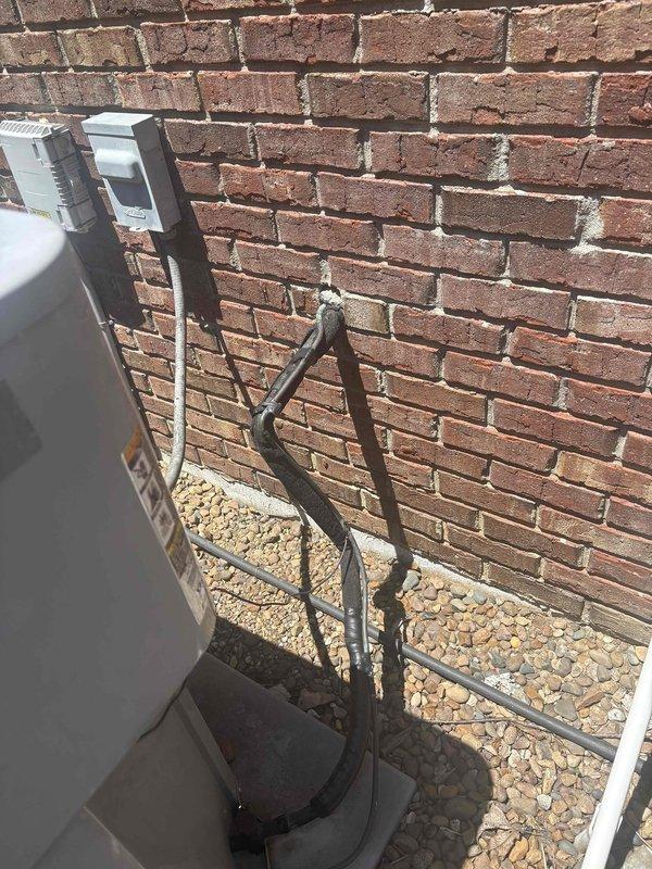 Conducted comprehensive replacement estimate for aging HVAC system experiencing intermittent operational issues. Evaluated existing outdoor condensing unit with refrigerant line set running along exterior brick wall to interior disconnect box, and assessed indoor climate control system including digital thermostat currently set at 76 degrees. Documented equipment configuration, electrical connections, refrigerant line routing, and overall system layout to provide homeowner with complete replacement options and recommendations for new high-efficiency heating and cooling equipment.