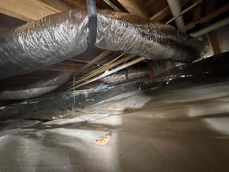 Installed additional 7-inch flexible supply duct runs in crawl space to serve kitchen window bench area. Ductwork was properly secured to floor joists using metal strapping, routed across existing vapor barrier, and insulated with reflective silver wrap to prevent heat loss and condensation. Installation completed in accordance with standard residential HVAC practices for conditioned air distribution.