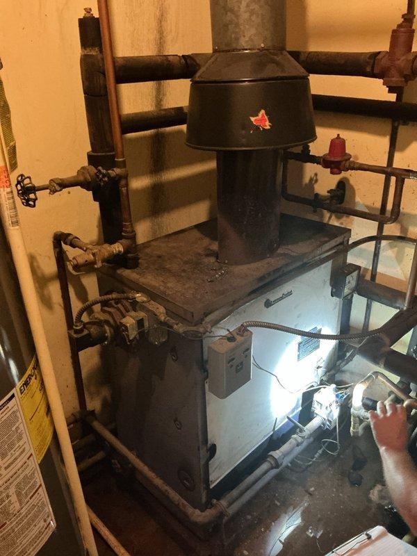 Conducted on-site assessment of existing boiler and hot water heating system in basement mechanical room. Documented current equipment configuration including boiler unit, expansion tank, and associated piping network, then provided comprehensive replacement quote for complete system upgrade.