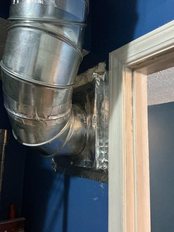 Completed warranty follow-up service to address air return vent installation issues. Sealed and taped the top of the return air ductwork at the wall penetration point to prevent air leakage and improve system efficiency. Applied proper sealing methods to the metal ductwork connections where they interface with the interior wall structure, ensuring adequate air sealing at the return air grille location.