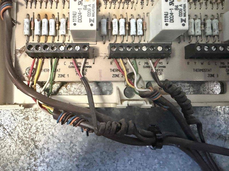 Responded to no cooling call on 3-year-old multi-zone HVAC system where thermostat was randomly switching between cooling and heating modes and failing to maintain setpoint of 70°F. Inspected zone control panel and main system control board, verified proper wiring connections across all three zones, and checked thermostat communication circuits. Diagnosed malfunctioning zone control board causing erratic thermostat behavior and improper mode switching. Replaced defective zone control module, verified proper thermostat response across all zones, and confirmed system now maintaining programmed temperature setpoints with stable cooling operation.